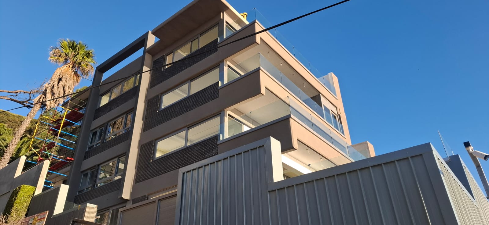 Completed multi-storey building with flush glass façade installation in Sea Point.