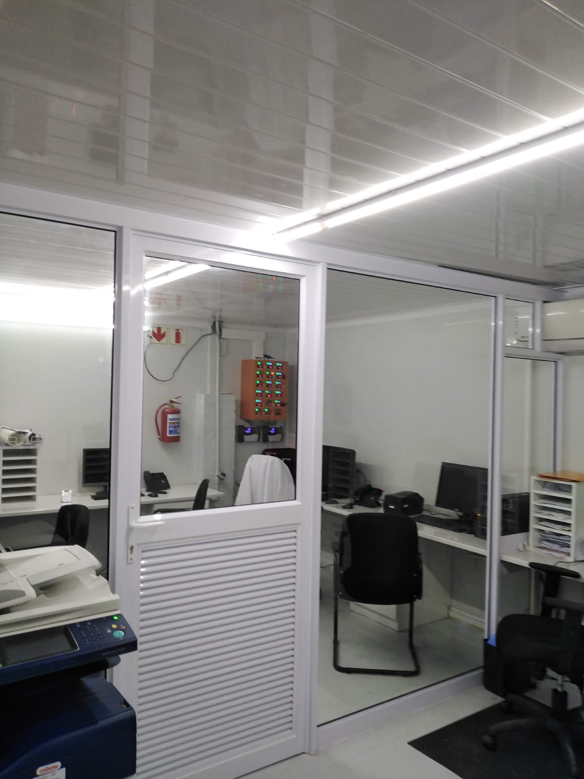 White aluminium sliding glass doors separating tills and kitchen at Mubarak Foods, Lansdowne.