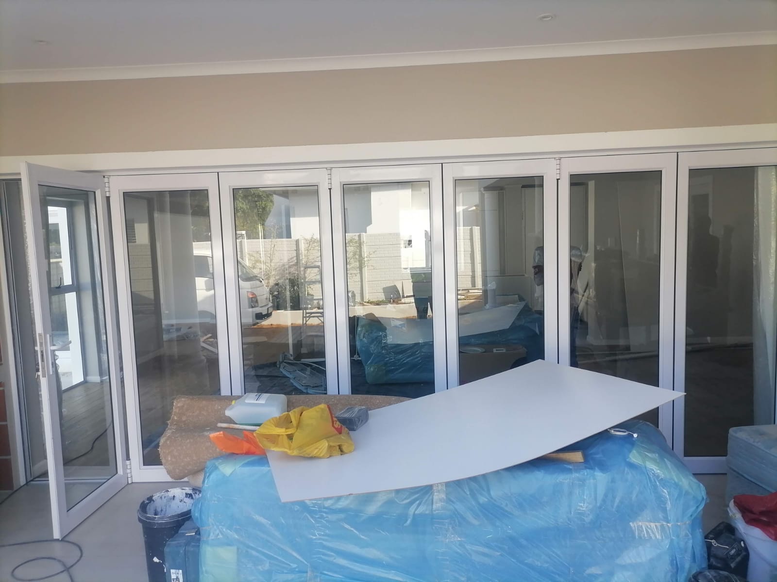 Large foldable white aluminium glass doors installed at the main entrance of Standard Bank, Cape Town.