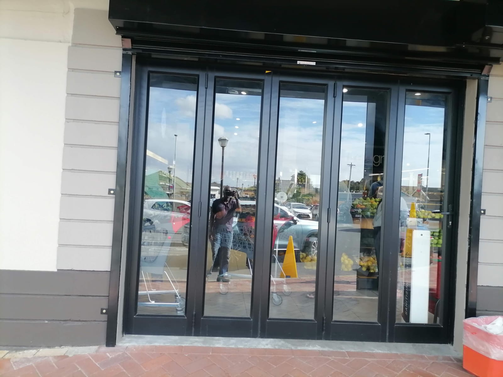 Close-up view of black-framed aluminium glass entrance doors at Kromboom Kwikspar.