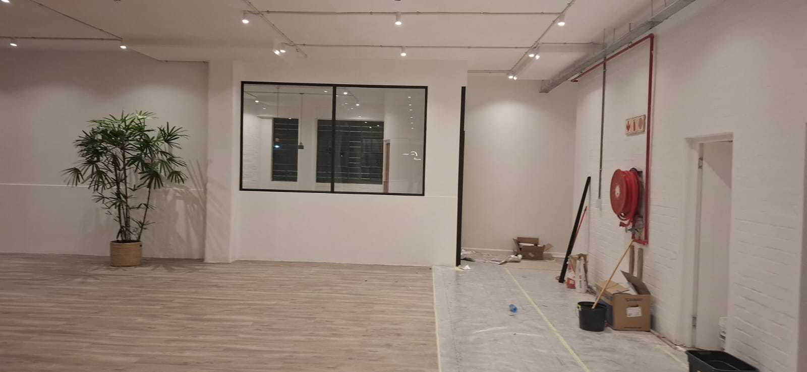 Interior view of Walden project showing aluminium slim shopfronts with black frames and glass panels installed in a modern workspace.