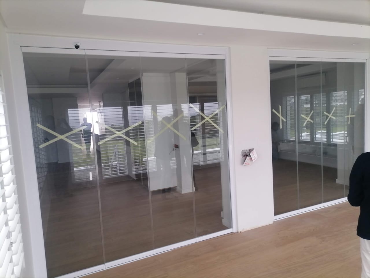 Frameless glass sliding and stacking doors closed across a full wall in Stellenbosch