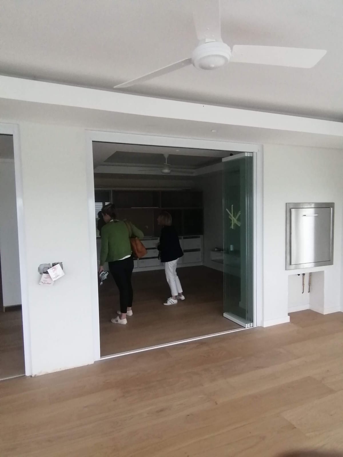 Wide view showing frameless sliding glass doors and large transparent wall openings.