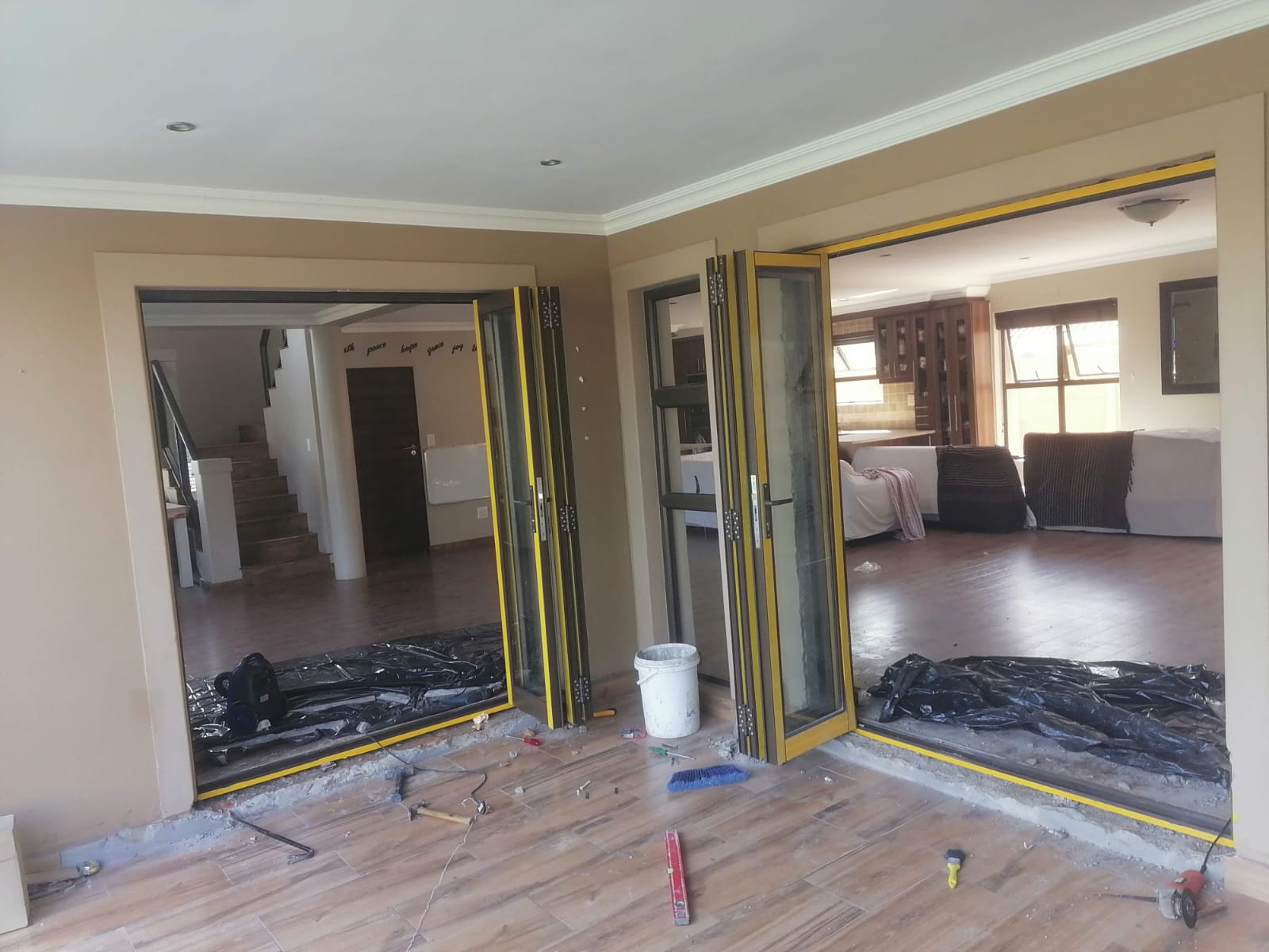 Aluminium stacking doors forming an L-shape across two adjoining walls in Durbanville.