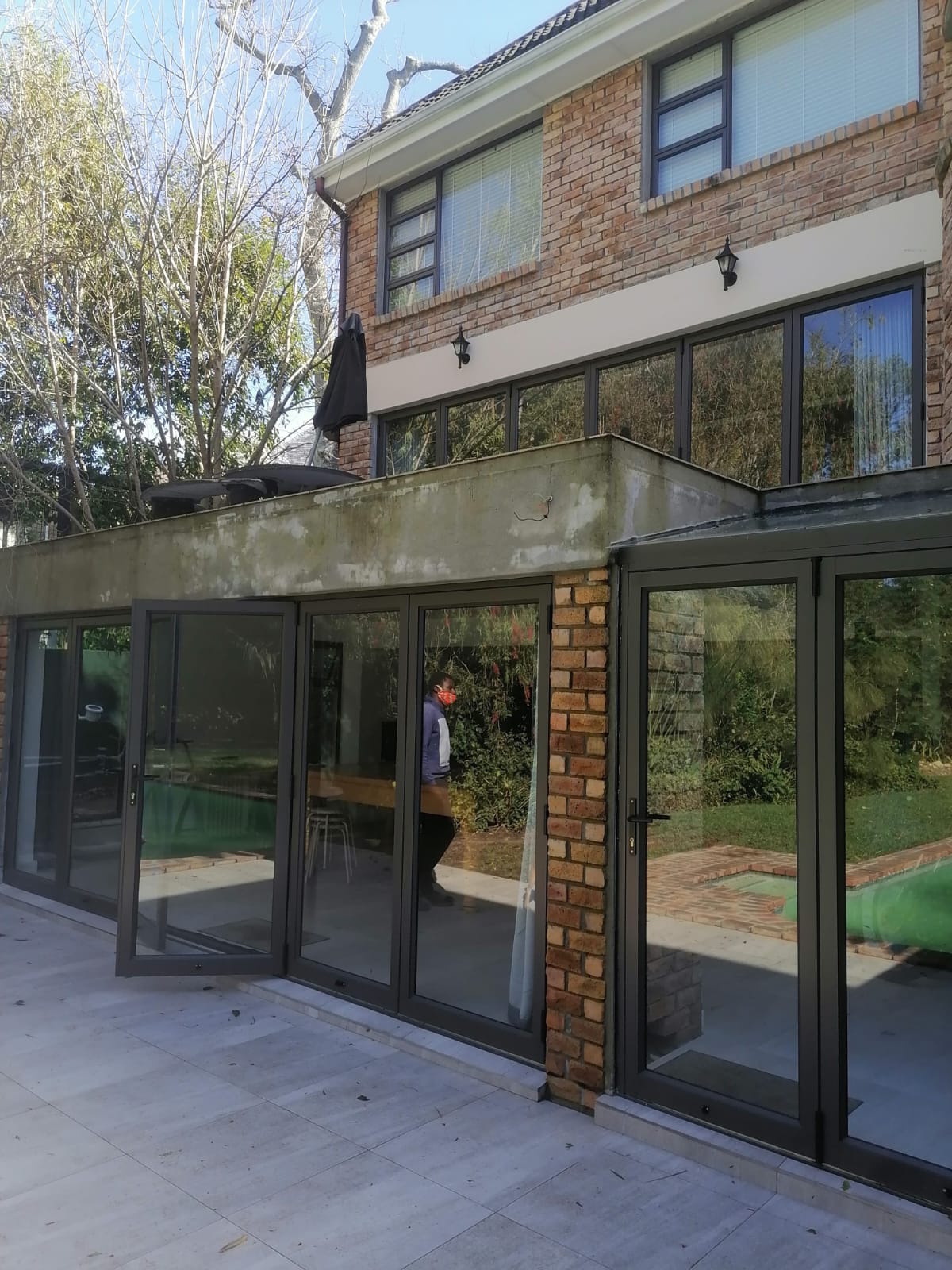 Double-storey Newlands home with aluminium sliding stacking doors and windows on both levels.