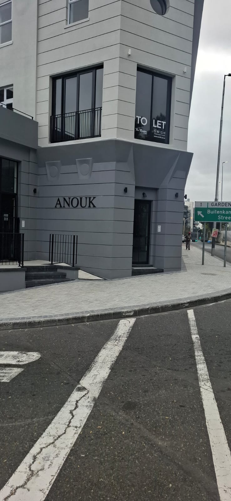 Alt text: Full view of the Avalon Building in Gardens, Cape Town, showing aluminium windows and glass shopfronts.