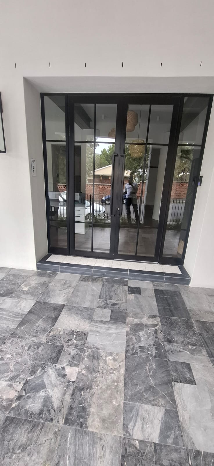 Aluminium and glass sliding door installed on the side of the Avalon Building in Cape Town.