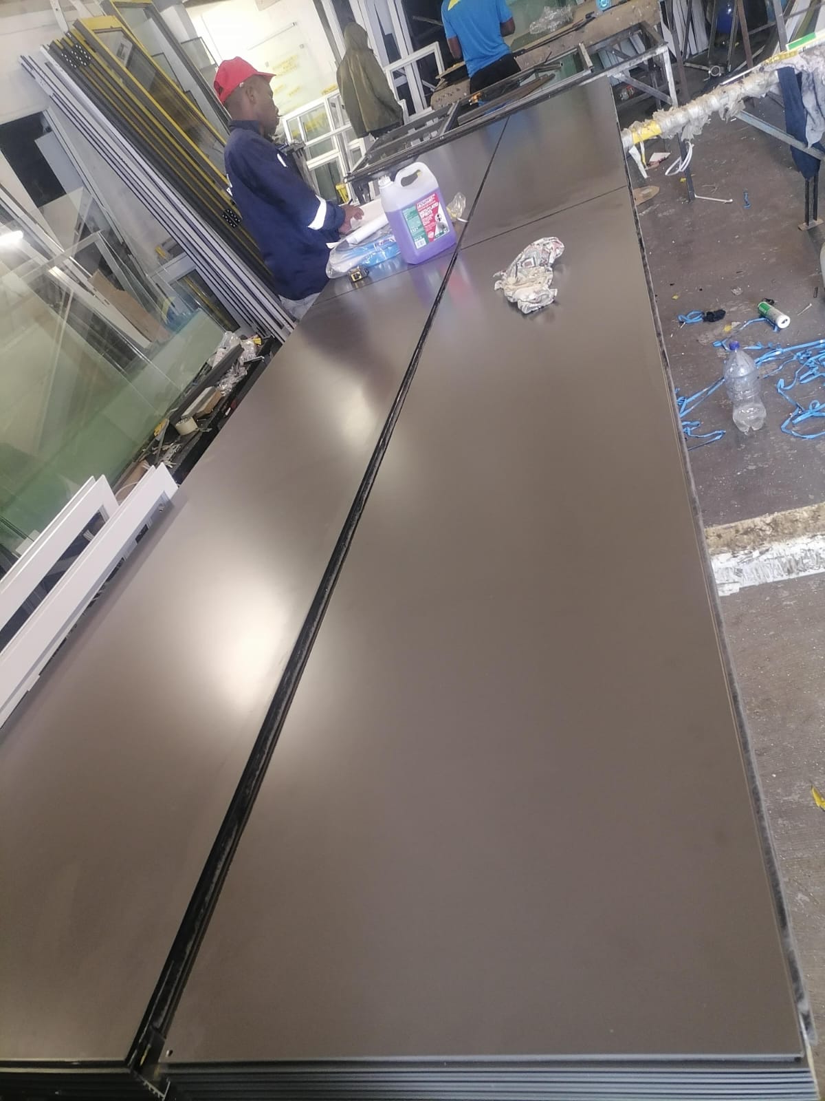 Technicians operating aluminium processing machines at Walden Aluminium Cape Town.